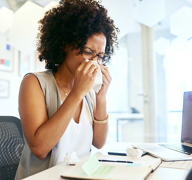 woman blowing her nose