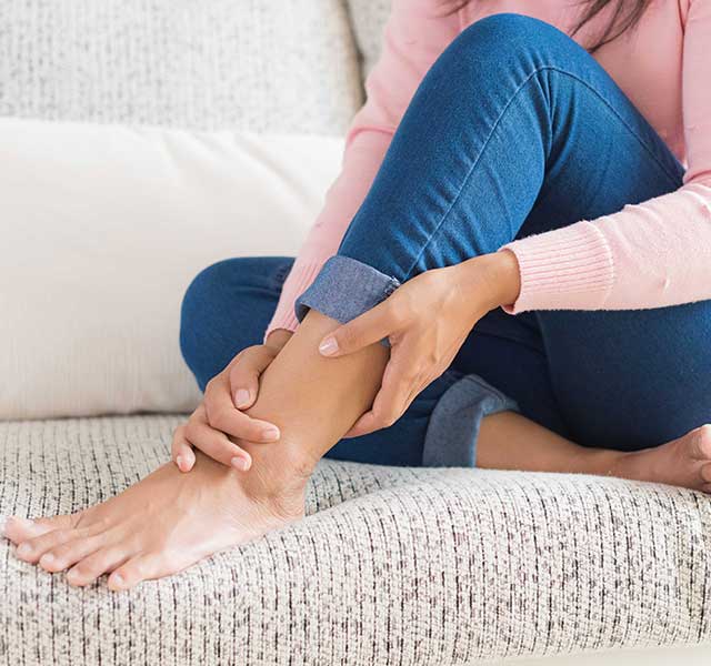 Woman struggling with symptoms of Restless Legs Syndrome