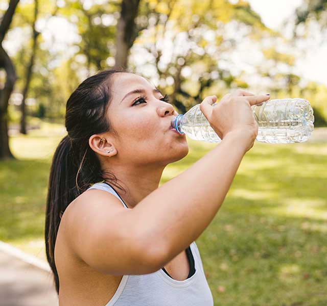 Athletic woman drinking too much water
