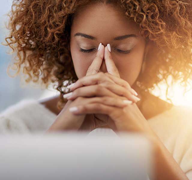 Worried woman researching cancer stages and survival rates on computer