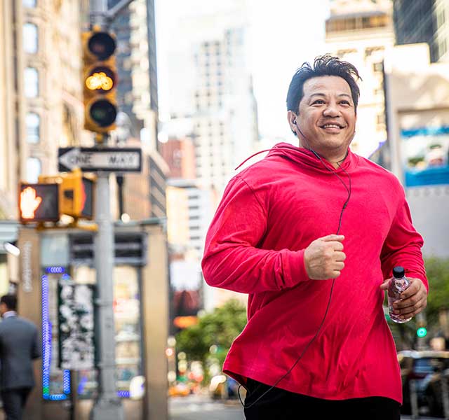man running on city street