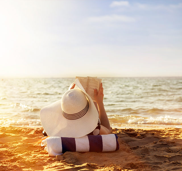 woman reading on beach