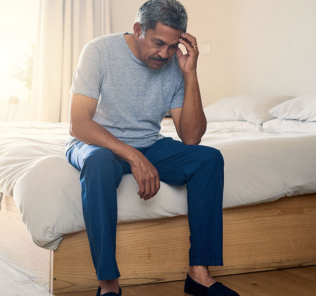 man sitting on bed