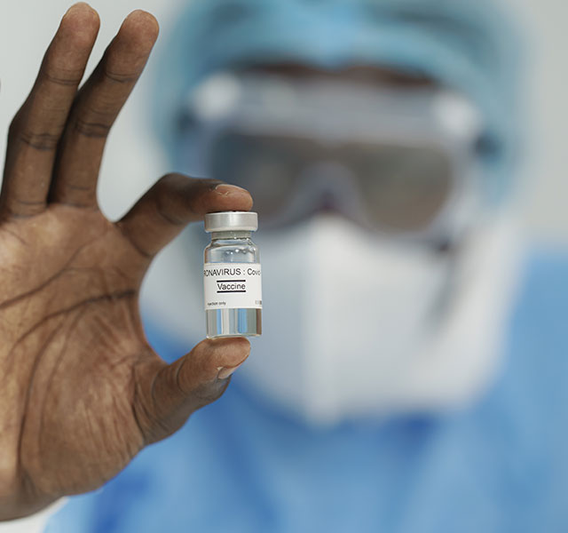 doctor holding covid vaccine