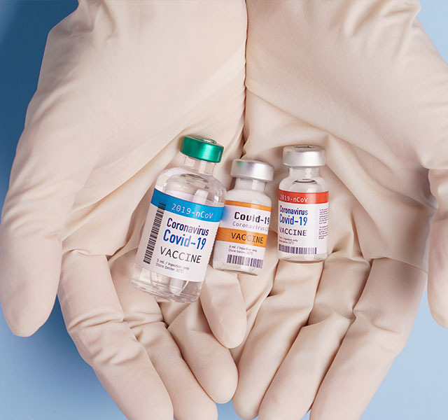 doctor holding vaccine bottles