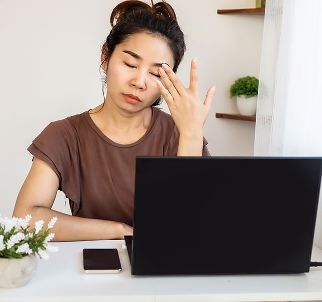 woman tired at her desk