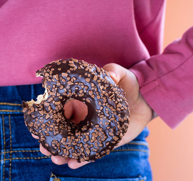 girl holding donut