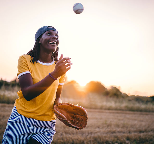 woman playing baseball