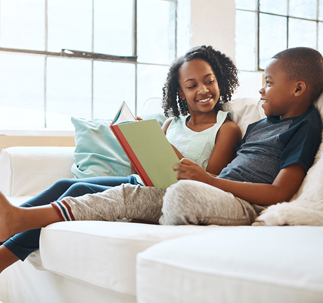 siblings reading together