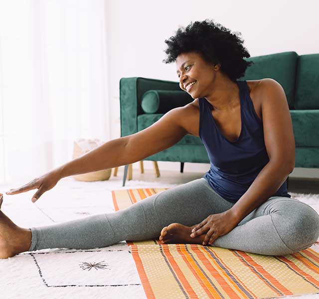 woman stretching at home