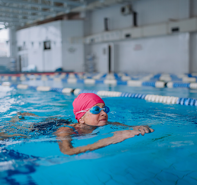 older woman swimming inside