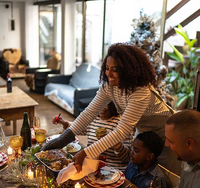 mother serving thanksgiving turkey