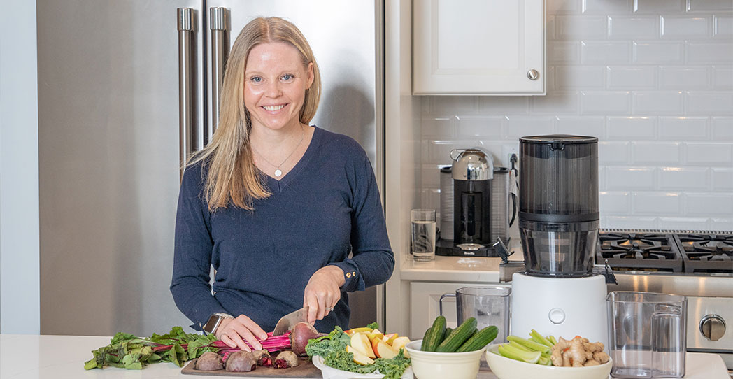 Colon cancer patient Brooke cutting up vegetables in her kitchen