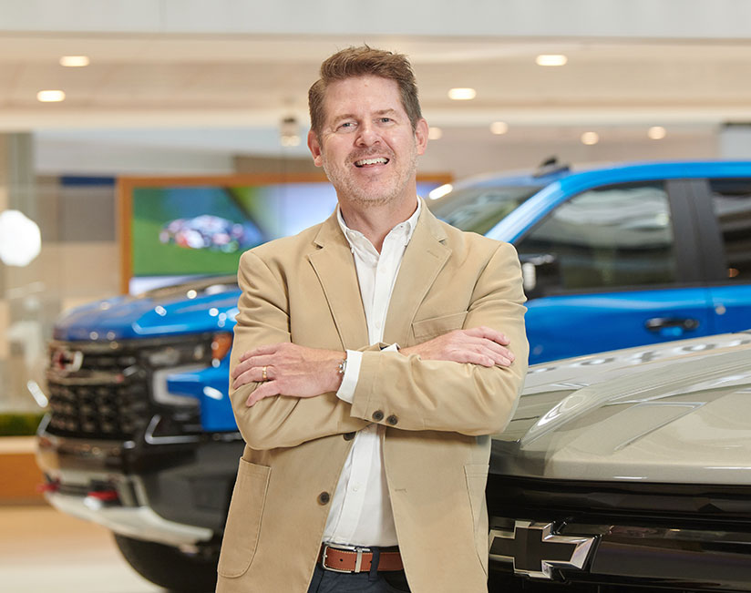 Darin posed in front of cars