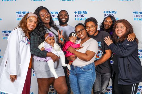 WIN Network certified nurse midwives and community health worker pose with WIN Network mothers, their babies, and support persons during the Group Prenatal Care Reunion in May 2025.
