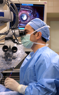 doctor looking through microscope