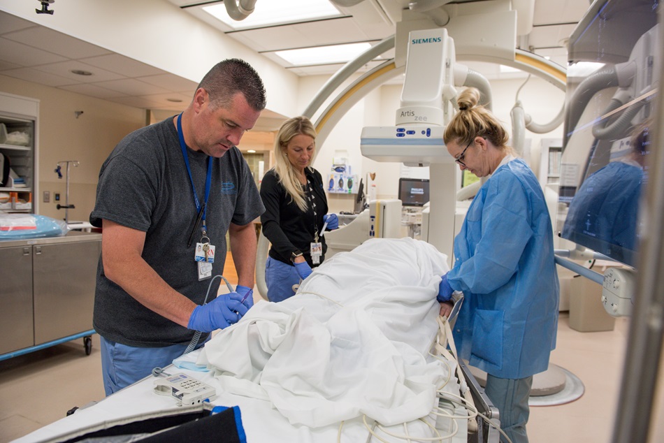 Radiology techs working on patient