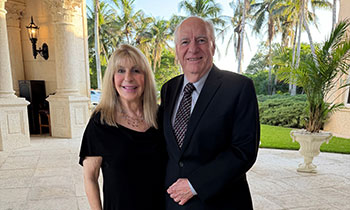 Eric and Ellen Prevost pose for photo at formal event.