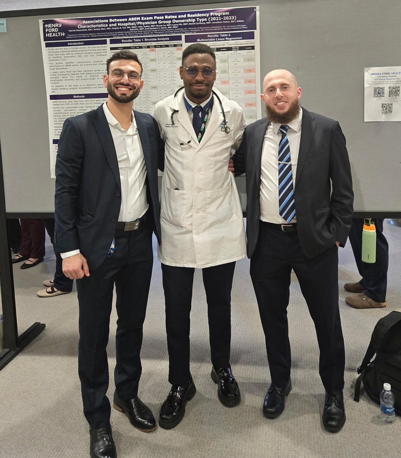Residents at conference with research presentation.