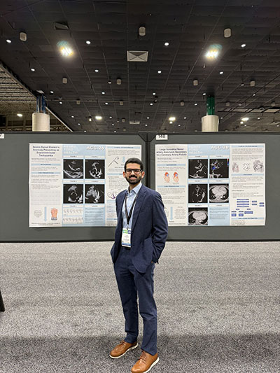 Fellow with presentation boards at conference