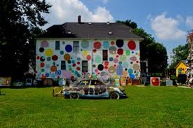 A view of the Heidelberg Project featuring a car and painted house