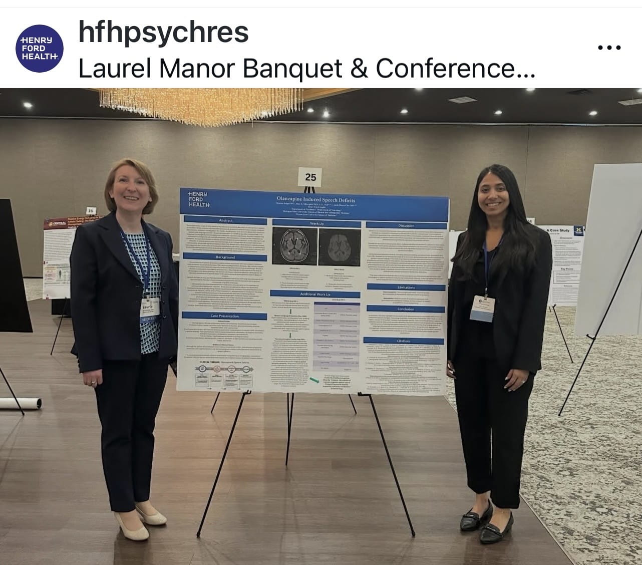 Residents with research posters at conference