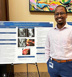 Family Medicine resident presents a clinical research poster at Henry Ford Health.