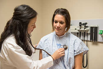 resident examining patient macomb internal medicine