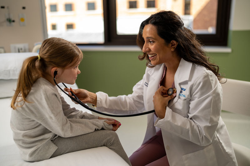 Pediatric patient listening to provider's heart