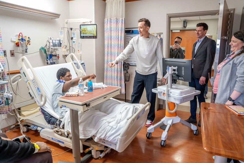 Pistons player visiting pediatric inpatient patient
