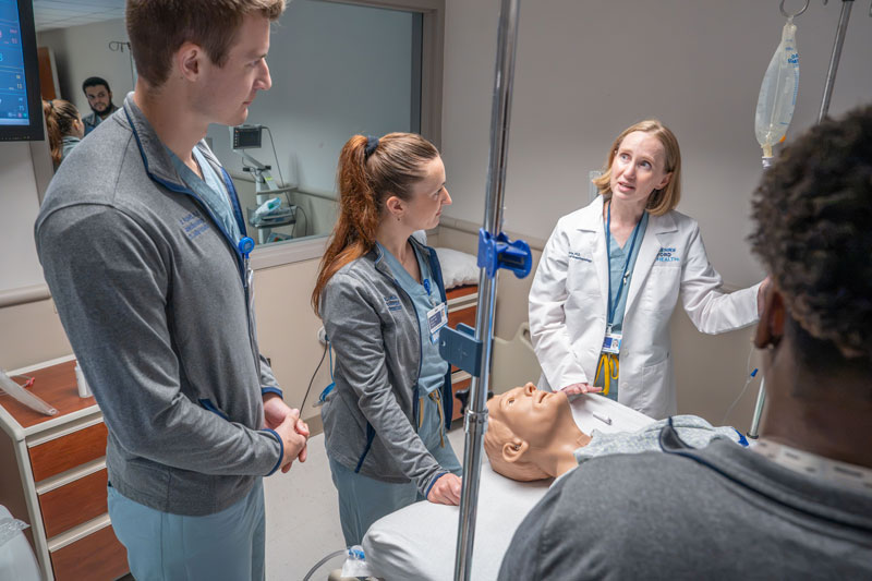 Pediatric faculty teaching residents in the simulation center