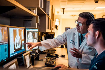 cancer researchers looking at brain scans