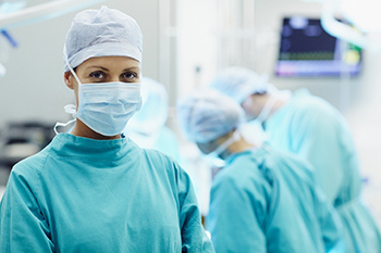 Surgical team preparing instruments for procedure