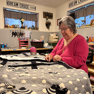 Liver cancer patient Brenda working on a quilt