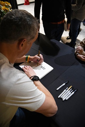 Dusty at a book signing, promoting his book on his cancer journey