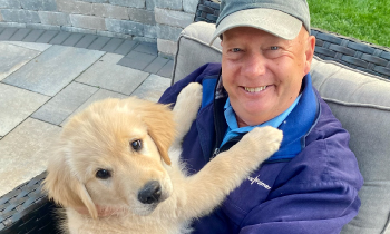 Prostate cancer patient, Ray, posing with his puppy