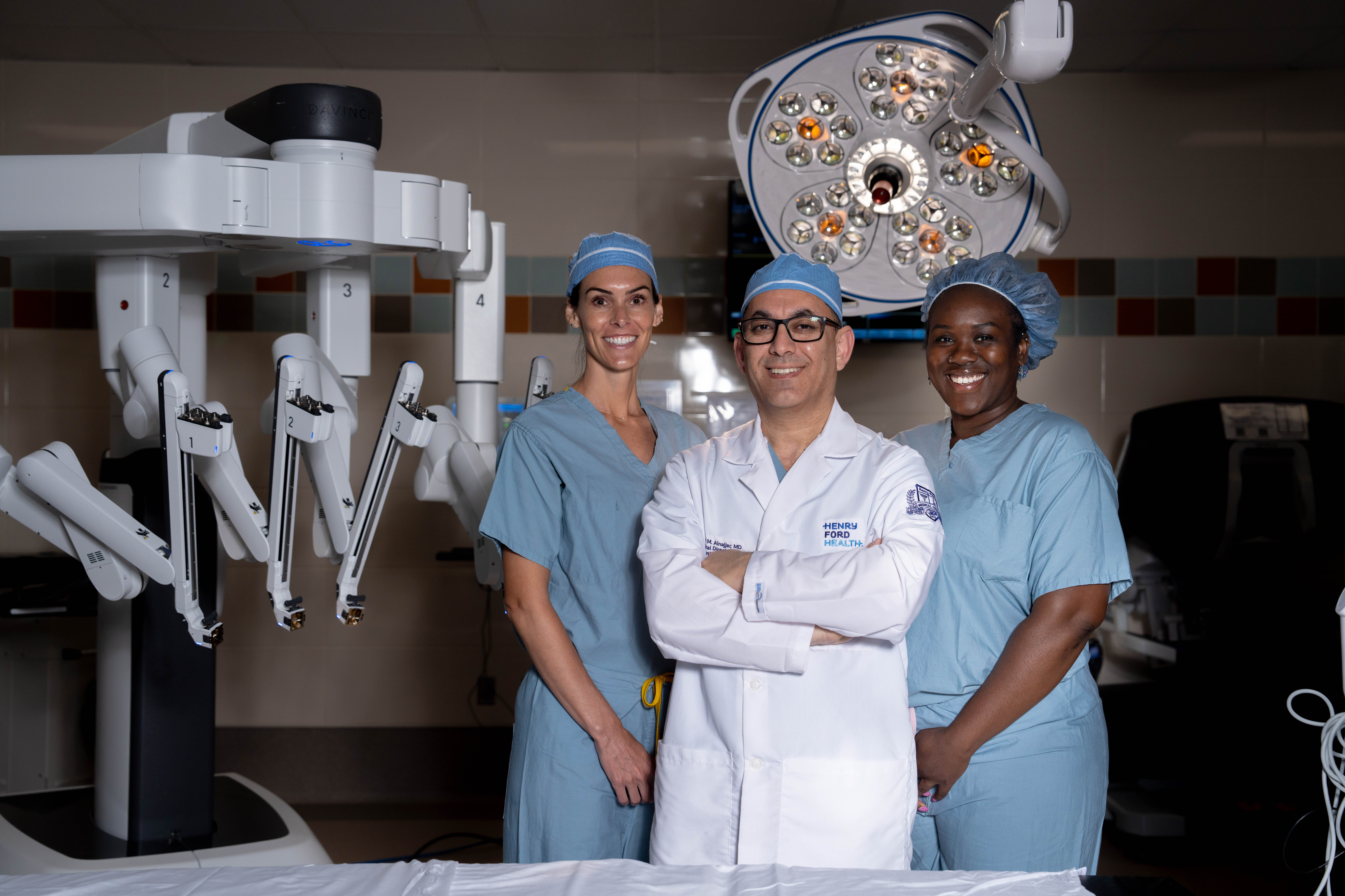 Surgical cancer care providers at Henry Ford Health pose with advanced surgical technology.