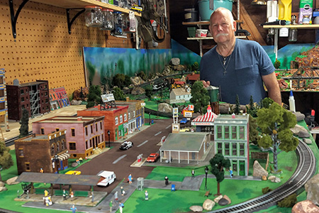 ENT patient Albert posed behind his train set