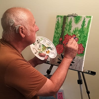 ENT patient Albert painting a picture