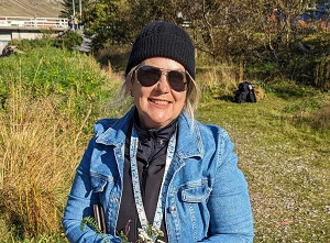 Headache patient, Gaye, standing in a field