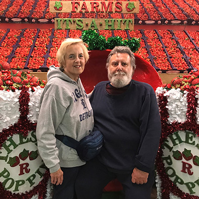 Patient Bob with his wife posing at a strawberry farm