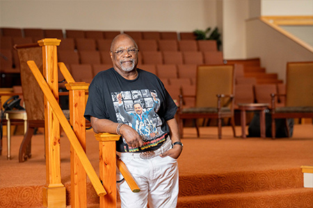 Reverend Anthony posed inside his church