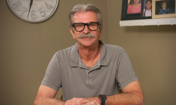 Iwan Mich, aortic disease patient at Henry Ford Health, smiling at home