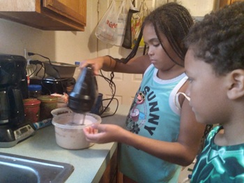 Two young children baking in the kitchen