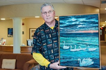 James Pujdowski, acupuncture patient at Henry Ford Health, showing off his painting