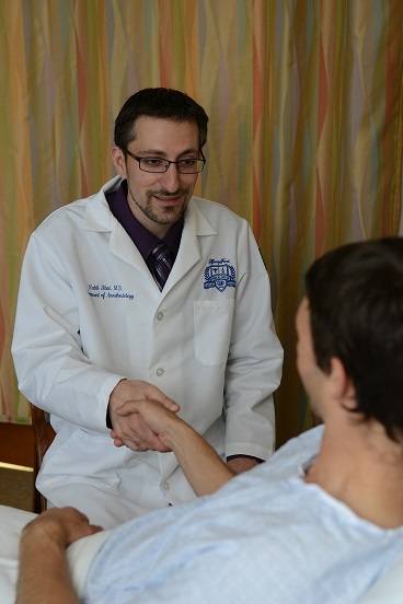 Doctor holding hand of Neurostimulation patient