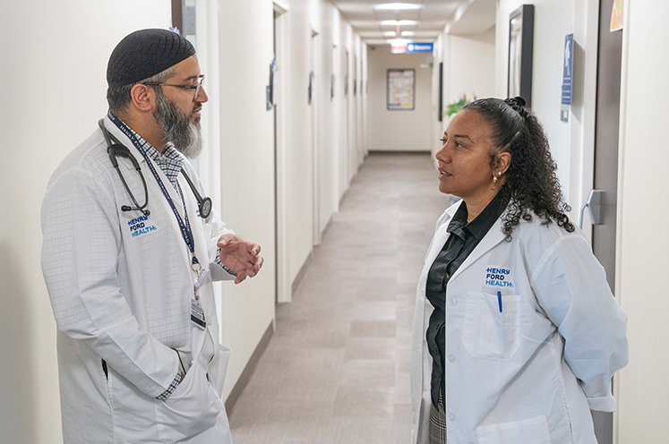 Dr. Asif Alavi and Jennifer R. Idrissu, NP, discuss sickle cell care at a Henry Ford Health clinic. 