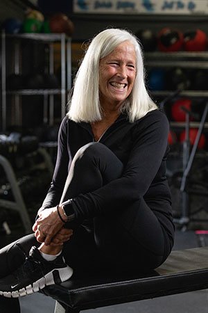 Alice Kolb posing on a weight bench