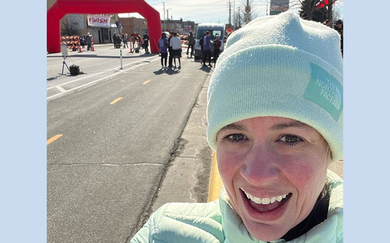 nancy posed with race finish line