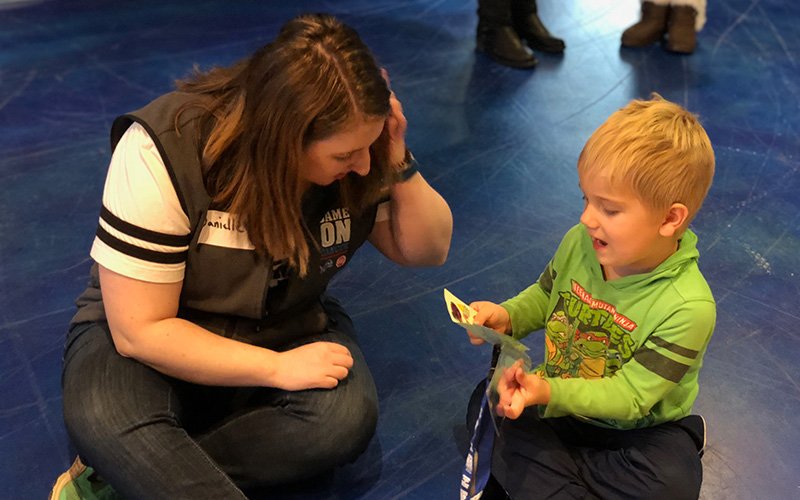 child at the game on cancer kids club event